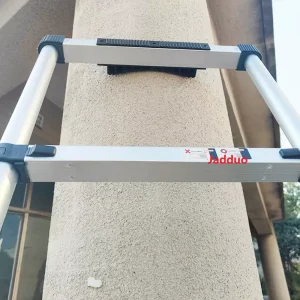 Close-up real photo of the one-key lock mechanism on Jadduo telescopic ladder, showing sturdy construction